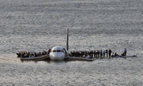 Passengers wait to be rescued on the wings of a US Airways plane that safely landed on the Hudson River in New York on January 15, 2009. 