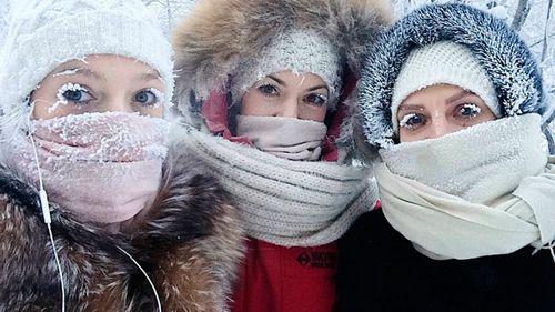 In this photo taken on Sunday, Jan. 14, 2018, Anastasia Gruzdeva, left, poses for selfie with her friends as the temperature dropped to about -50 degrees (-58 degrees Fahrenheit) in Yakutsk, Russia. Temperatures in the remote, diamond-rich Russian region of Yakutia have dropped to near-record lows, plunging to -67 degrees Centigrade (-88.6 degrees Fahrenheit) in some areas. (sakhalife.ru photo via AP)