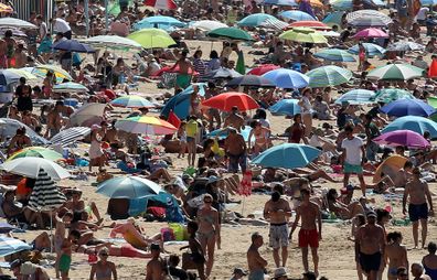 People sunbathe in Saint Jean de Luz' beach, southwestern France, Saturday, July 18, 2020. 