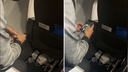 Woman catches man taking photos of her feet during flight