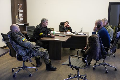 Former Ukrainian President Petro Poroshenko, second left, attends a meeting in the City Hall in Kyiv, Ukraine, Sunday, Feb. 27, 2022.