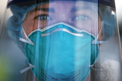 A registered nurse is seen wearing PPE at a Bondi Beach COVID-19 drive-through testing clinic, in Sydney, Australia.