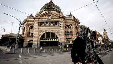 A woman is seen wearing a face mask out Flinders Street Station on July 23, 2020 in Melbourne, Australia. 