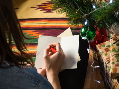 Woman writing Christmas cards