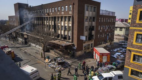 Medics and emergency works at the scene of the deadly blaze in downtown Johannesburg Thursday, Aug. 31, 2023.