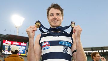 Isaac Smith of the Cats poses with his Norm Smith medal.