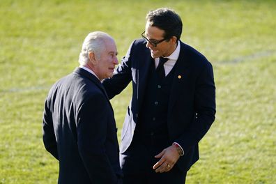 King Charles III speaks to Wrexham Soccer team co owner US actor Ryan Reynolds, during their visit to Wrexham Association Football Club's Racecourse Ground, in Wrexham, England, Friday, Dec. 9, 2022.