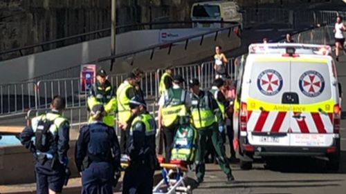 Paramedics treated the runner near the Sydney Opera House steps.