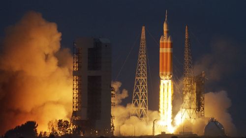 NASA's Orion spacecraft, atop a United Launch Alliance Delta 4-Heavy rocket, lifts off on its first unmanned orbital test flight from Cape Canaveral in Florida. (AAP)