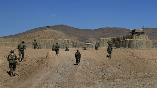 In this 2012 file photo, Australian troops enter Patrol Base Wali after a patrol with Afghan National Army soldiers in the Mirabad Valley, Afghanistan.