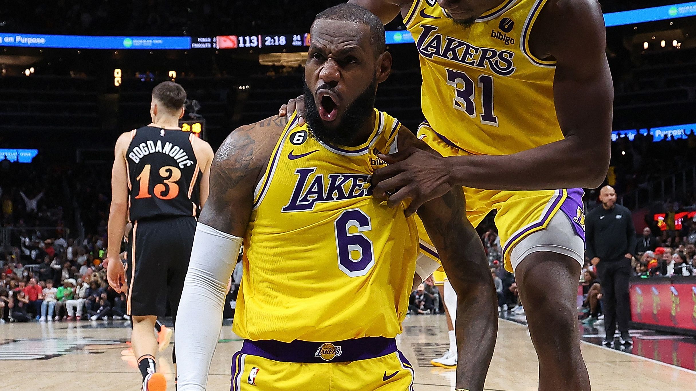 LeBron James #6 of the Los Angeles Lakers reacts with Thomas Bryant #31 after drawing a foul on a basket against the Atlanta Hawks during the fourth quarter at State Farm Arena on December 30, 2022 in Atlanta, Georgia. (Photo by Kevin C. Cox/Getty Images)