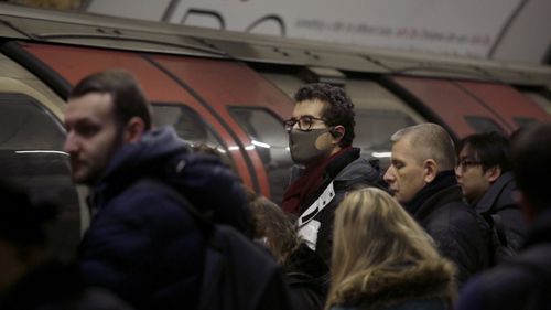 A man wearing a face mask on the London Underground.