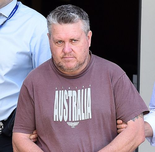 Rick Thorburn is escorted by police from the Logan Central Police Station to the Police Watchhouse in Brisbane in 2016. (AAP)