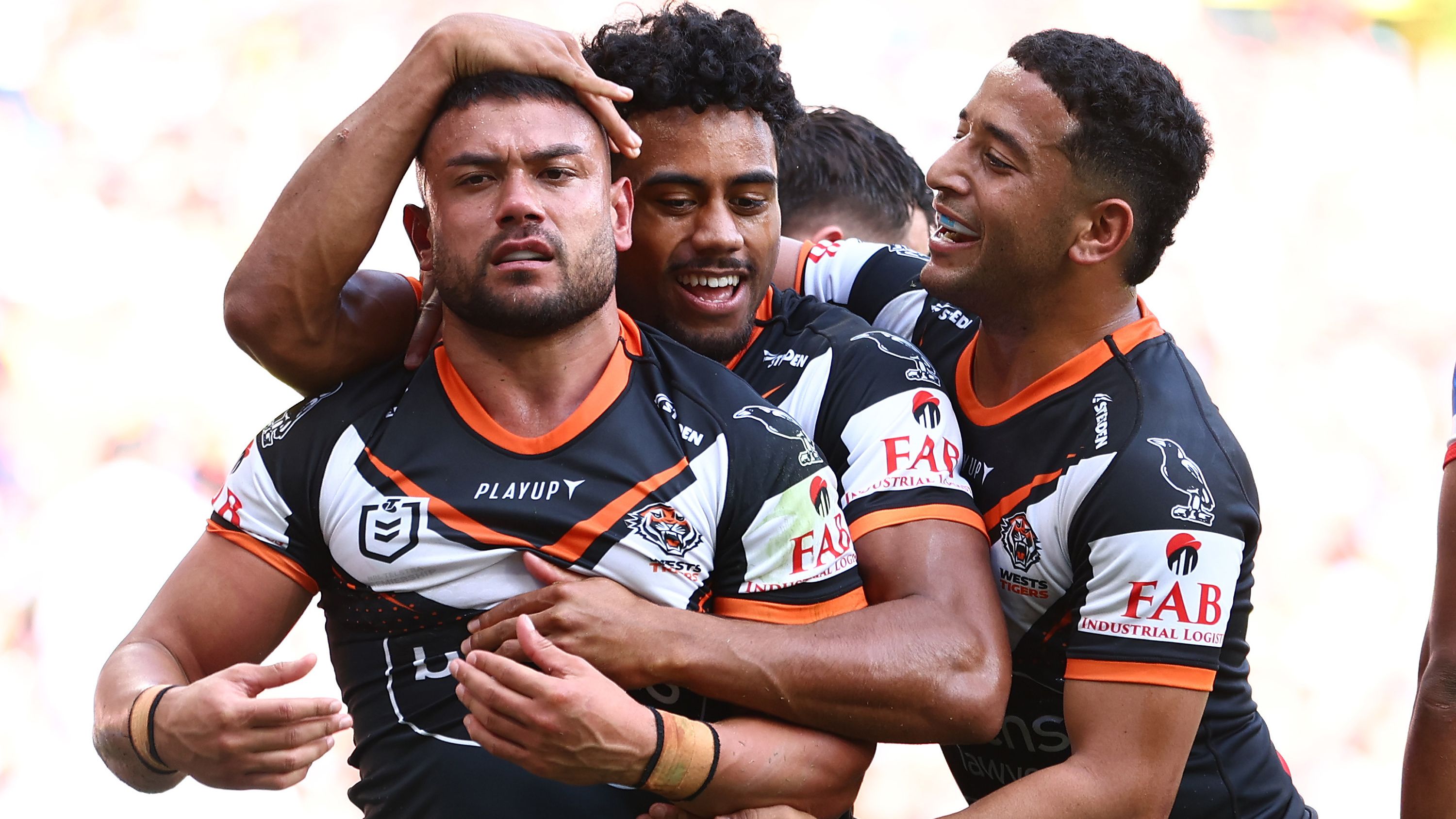 David Nofoaluma of the Wests Tigers celebrates with teammates after scoring a try against the St George Illawarra Dragons.