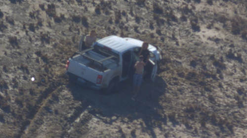 Three stranded teenagers have been rescued after their "help" sign written in sand was spotted pilots flying over Western Australia.