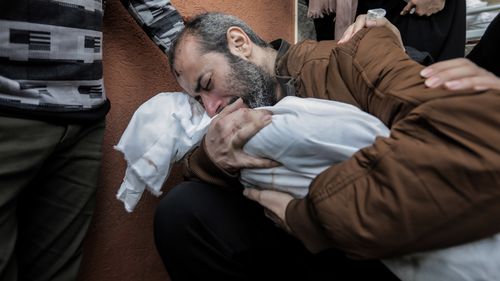 A father cradles his dead five-year-old son in Khan Yunis, Gaza.