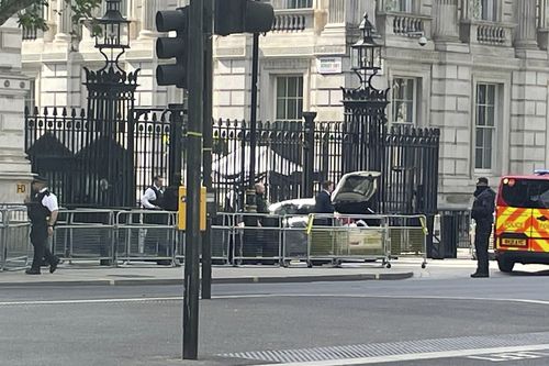 Police at the scene after a car collided with the gates of Downing Street in London Thursday May 25, 2023.