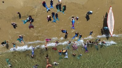 Members of the Israeli Mermaids Community swim with their mermaid tails at the Mediterranean Sea in Bat Yam, near Tel Aviv, Israel, Friday, July 21, 2023.