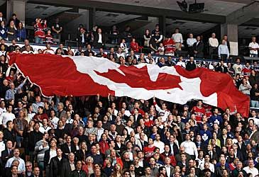 When did Canada adopt the Maple Leaf flag?