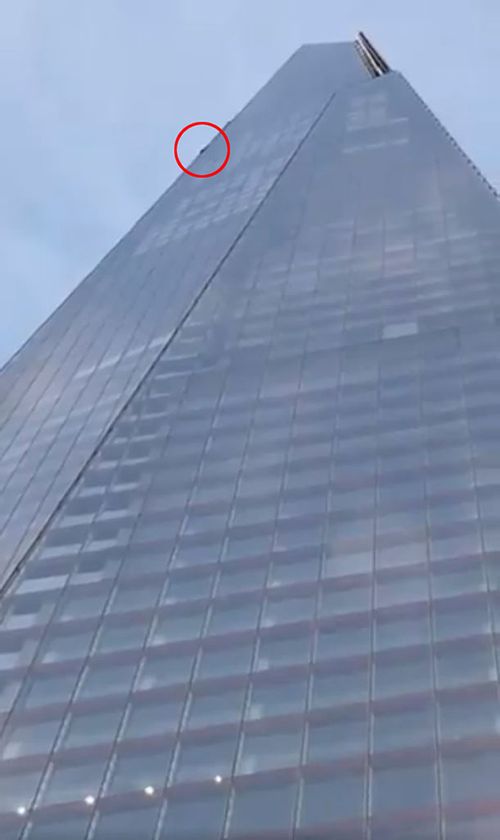 A daredevil free climber scaling The Shard, one of the tallest buildings in Europe.