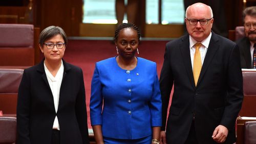 Senator Gichuhi flanked by Shadow Minister for Foreign Affairs Penny Wong and Attorney-General George Brandis. (AAP)