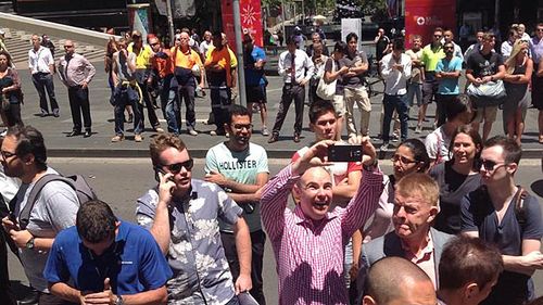 A man is shown taking a selfie near the scene.