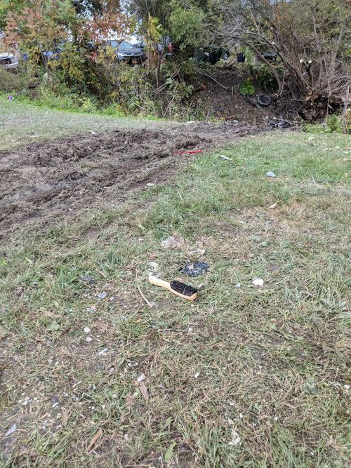 NY Times reporter takes photos of skid marks and a hairbrush at the scene.