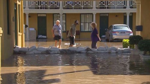 Locals in Ballina check sandbags after the Richmond river burst its banks.