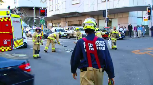 There are traffic delays of 20 minutes in the streets surrounding Elizabeth and Goulburn Streets after a crash where a truck clipped a building.