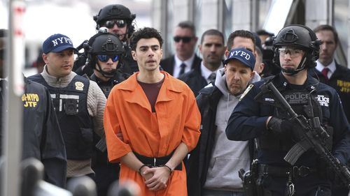 Luigi Mangione, a suspect in the fatal shooting of UnitedHealthcare CEO Brian Thompson, is escorted by police, Thursday, Dec. 19, 2024, in New York. (AP Photo/Pamela Smith)