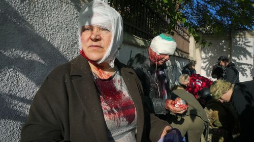 People receive medical treatment at the scene of Russian shelling, in Kyiv, Ukraine.