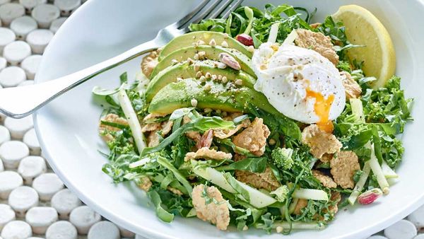 Gluten free breakfast salad with poached egg and avocado