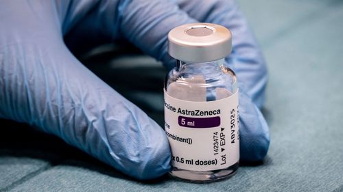 A medical professional holds a vial of the AstraZenica coronavirus vaccine.