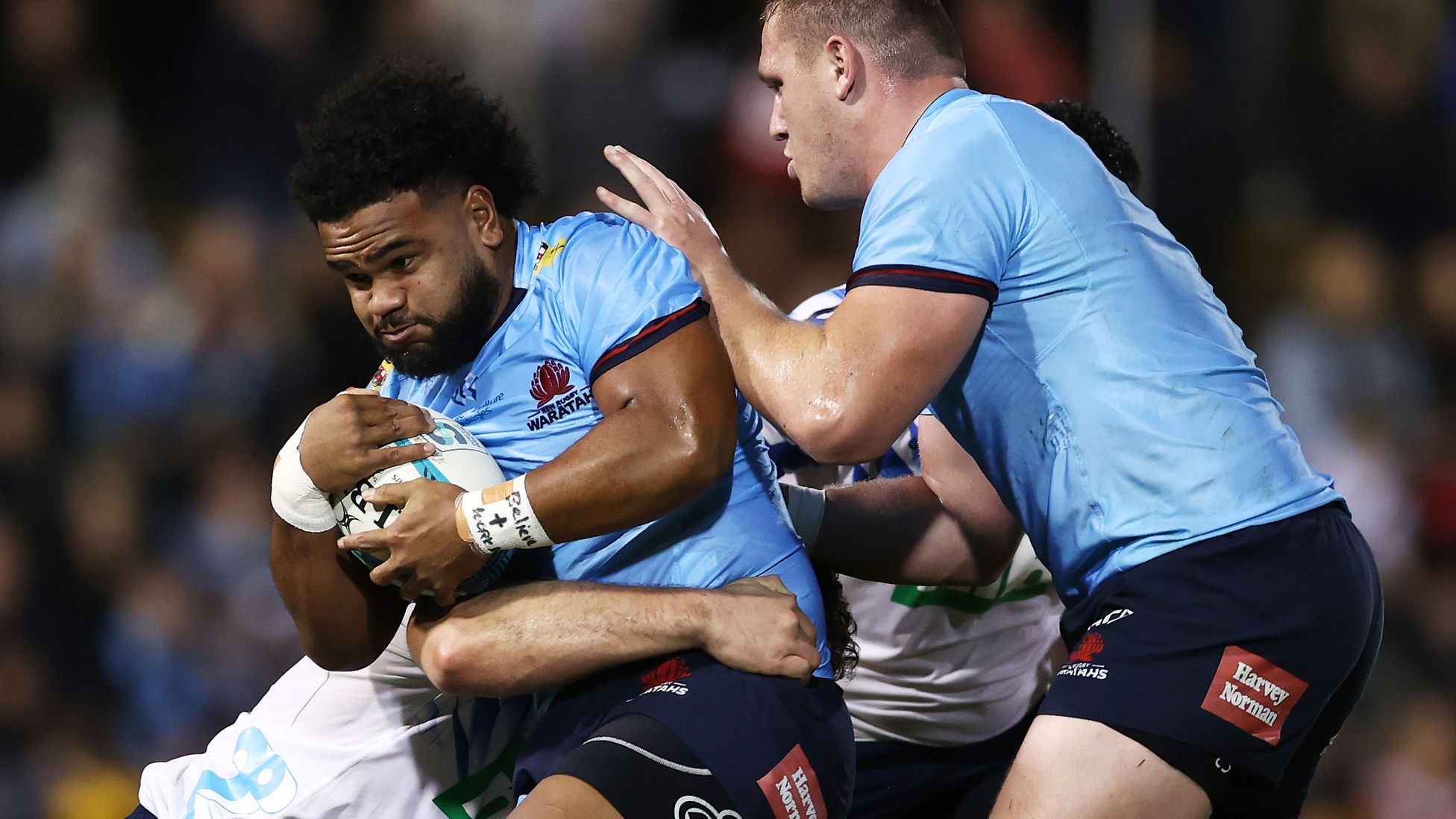 Mahe Vailanu of the Waratahs is tackled during the round 15 Super Rugby Pacific match between the NSW Waratahs and the Blues at Leichhardt Oval.