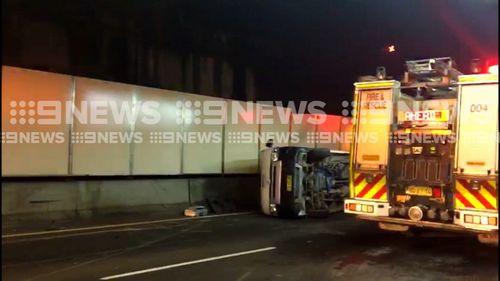 A ute was tipped on the Eastern Distributor, spilling concrete onto the road. (9NEWS)