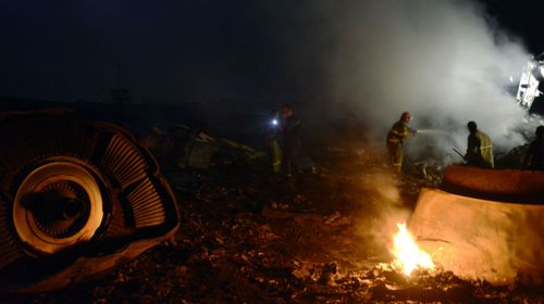Firefighters extinguish a fire amongst the wreckages of the malaysian airliner carrying 295 people from Amsterdam to Kuala Lumpur after it crashed in rebel-held east Ukraine. (Getty)