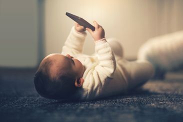 Baby holding a smartphone 