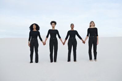 Women dressed in black holding hands