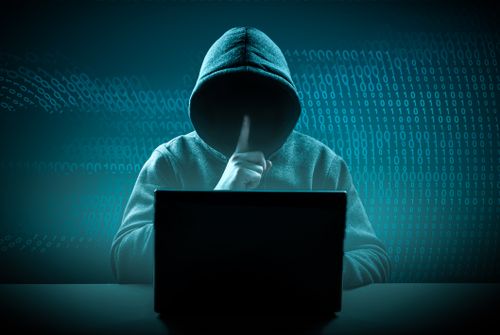 faceless hooded hacker showing soundlessness gesture. Hacker attack. Dangerous Hooded Hacker Breaks into Government Data Servers. Cybersecurity, machine hacker pinch hoodie. Hacking and malware concept.