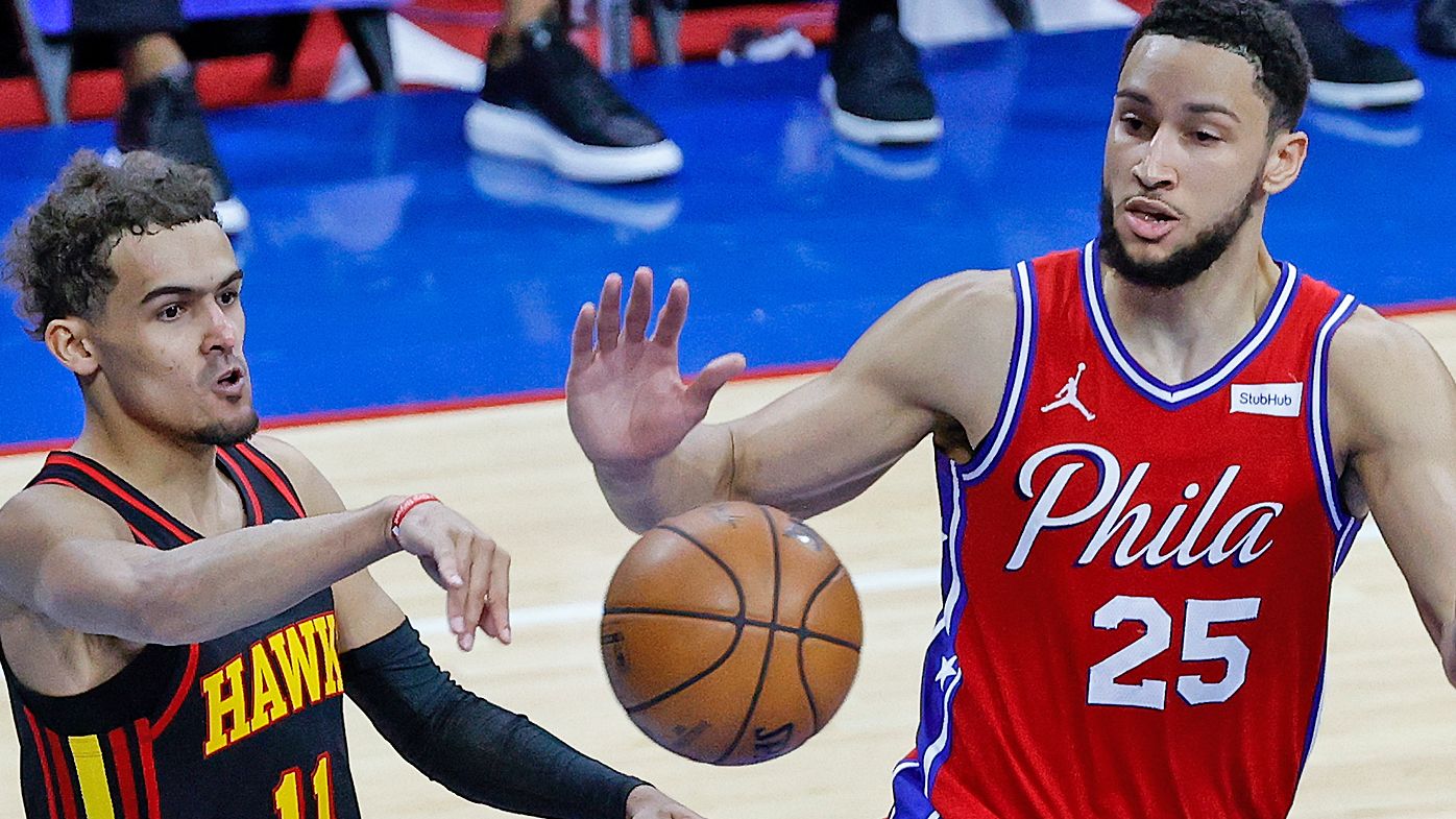 Trae Young #11 of the Atlanta Hawks passes past Ben Simmons #25 of the Philadelphia 76ers 