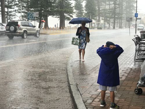 A heavy downpour hit Manly at 2pm. Picture: Josh Martin