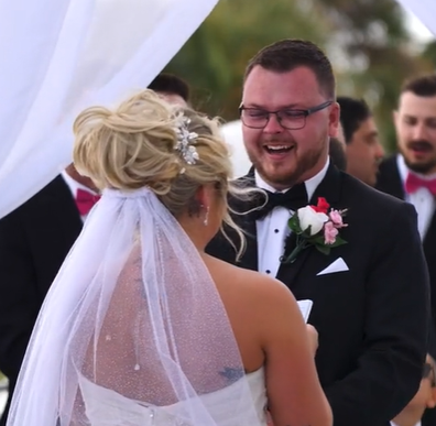 Bride and groom interrupted by bird at wedding
