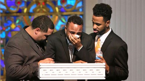 Sons Michael Marquez, Isaiah Henderson and Robert Presley grieve during the funeral of Pulse shooting victim Brenda Lee Marquez McCool. (AAP)