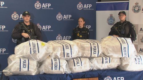 AFP officers stand next to the 320-kilogram cocaine haul in Western Australia.