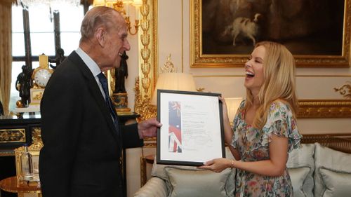 The Duke of Edinburgh presents Kylie Minogue with the 2016 Britain-Australia Society Award. (AAP)