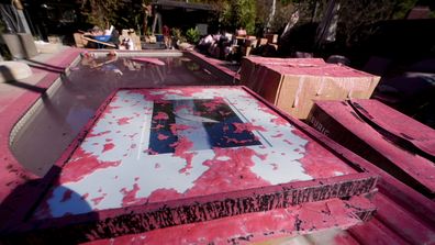 Retardant covers a framed photograph after crews battled the Palisades Fire in Mandeville Canyon Wednesday, Jan. 3, 2024, in Los Angeles. (AP Photo/Richard Vogel)