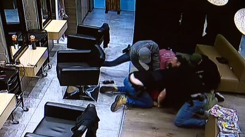 One officer can be seen punching the suspect multiple times as they try to restrain him. Picture: Supplied