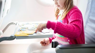 Little girl travelling on a plane