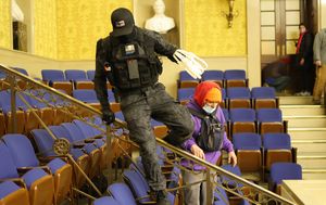 Two men carrying plastic restraints during Capitol riot charged by federal authorities