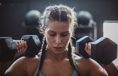 Woman working out with dumbells